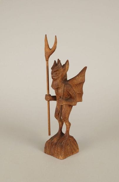 20th century. Winged devil holding pitchfork...