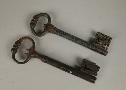 Two wrought-iron keys, one with an oval ring...