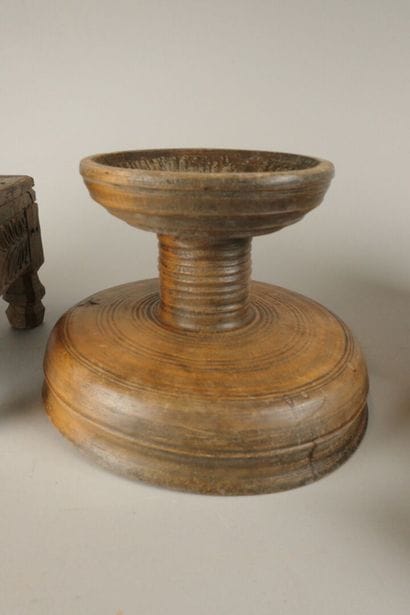 A small coffee table made of wood carved...