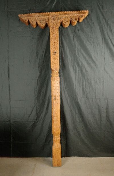 Carved pine column with a console decorated...