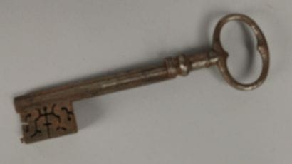Wrought-iron key with an oval ring featuring...