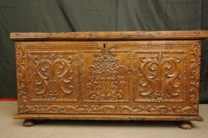 Natural wood cabinet with a carved three-panel...