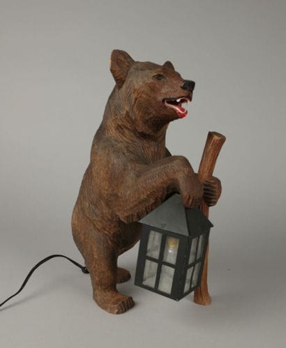 Painted, carved wooden bear with a lantern
That...