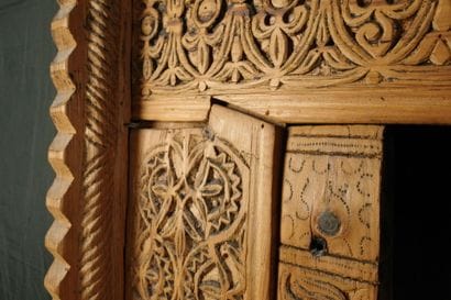 Antique wooden facade richly carved with...