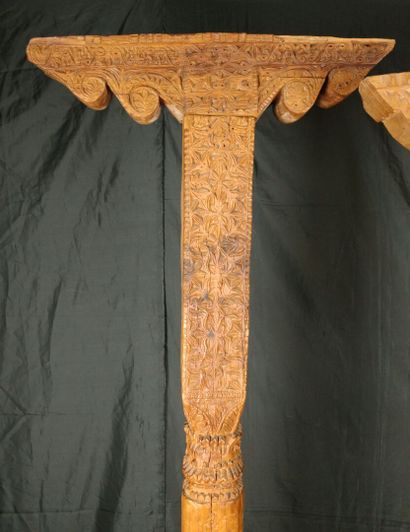 Two carved pine columns with consoles decorated...