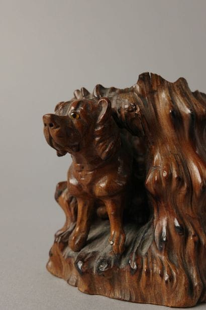 A finely carved boxwood match holder featuring...