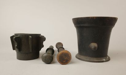 Two mortars and their pestles, one cast iron...