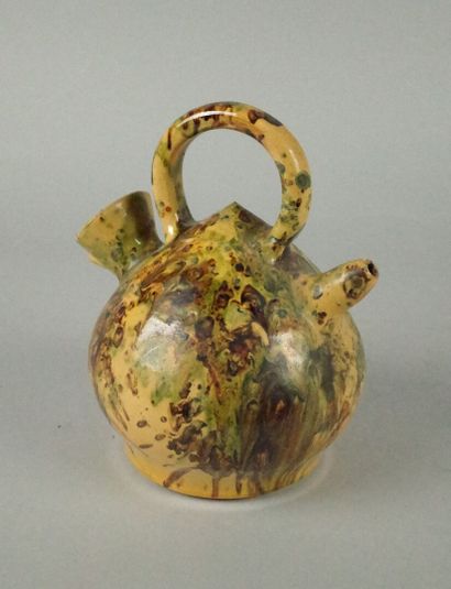 Glazed terracotta jug with a marbled design...