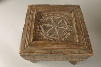 A small coffee table made of wood carved...