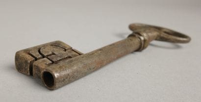 Wrought-iron key with an oval ring featuring...