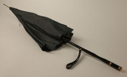 Black nylon parasol, with a black leather-covered...