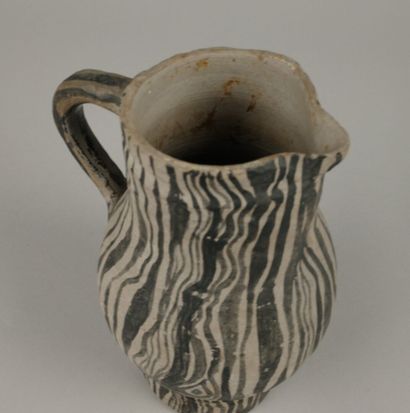 Gray ceramic carafe designed to resemble...