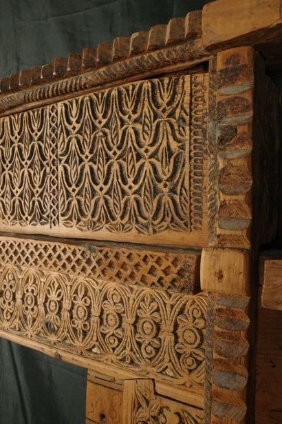 Antique wooden facade richly carved with...