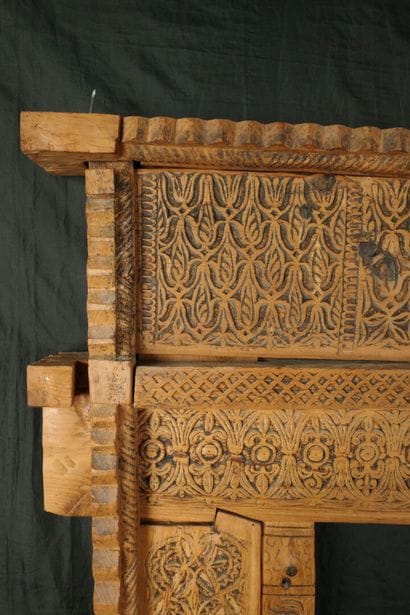 Antique wooden facade richly carved with...
