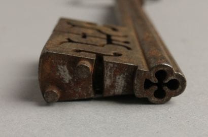 Wrought-iron key with an oval ring featuring...
