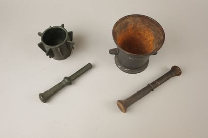 Two mortars and their pestles, one cast iron...