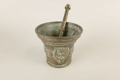 Bronze mortar decorated with a crowned head,...