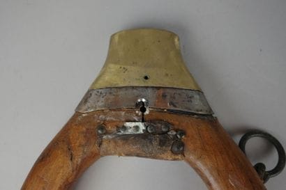 Wooden, brass, and leather donkey yoke with...