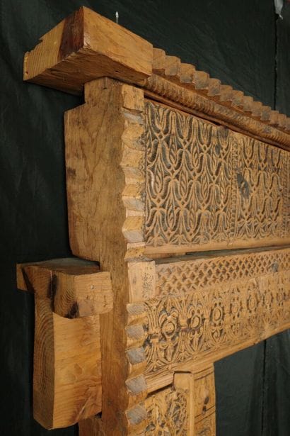 Antique wooden facade richly carved with...