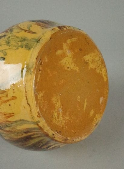 Glazed terracotta jug with a marbled design...