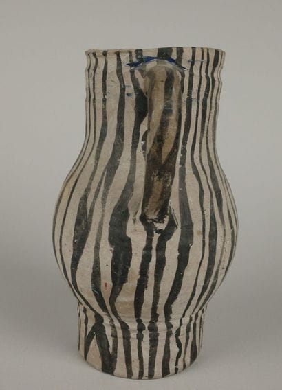 Gray ceramic carafe designed to resemble...
