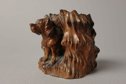 A finely carved boxwood match holder featuring...