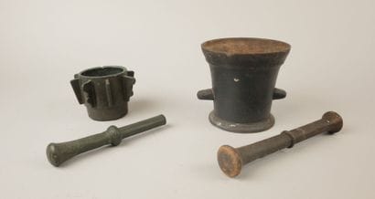 Two mortars and their pestles, one cast iron...