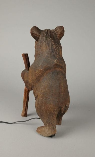 Painted, carved wooden bear with a lantern
That...