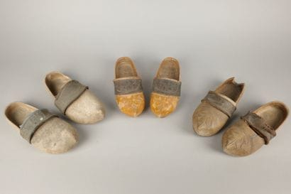 Three pairs of wooden clogs with leather...