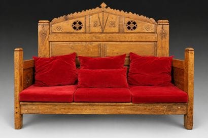Daybed with a solid, crenellated headboard...