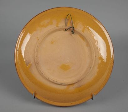 Glazed ceramic plate with a polychrome design...