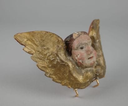 Baroque winged putto head, carved from polychrome...