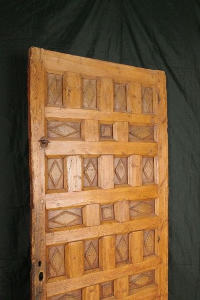 Antique paneled door carved with diamond-shaped...