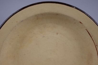 Glazed ceramic plate with a yellow center...