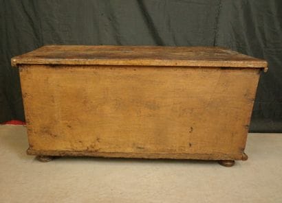 Natural wood cabinet with a carved three-panel...