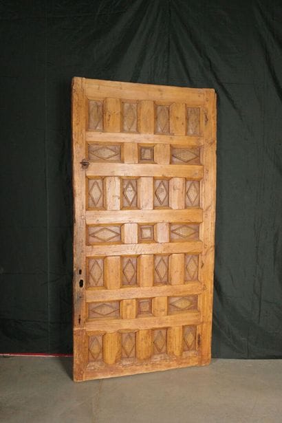 Antique paneled door carved with diamond-shaped...