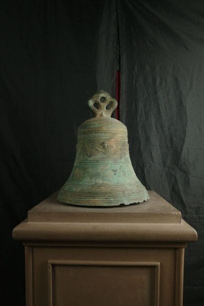 Large bronze bell decorated with angel heads...