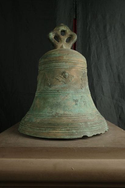 Large bronze bell decorated with angel heads...