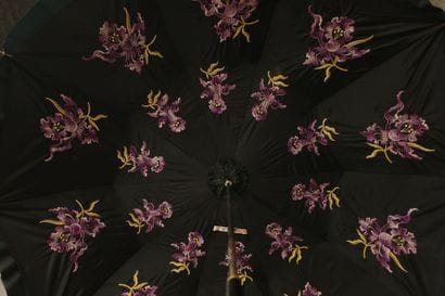 Black nylon parasol, with a black leather-covered...