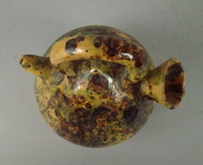 Glazed terracotta jug with a marbled design...