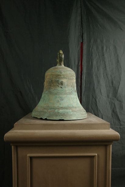 Large bronze bell decorated with angel heads...
