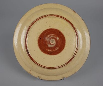 Glazed ceramic plate with a yellow center...