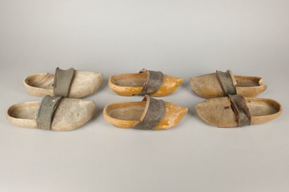 Three pairs of wooden clogs with leather...