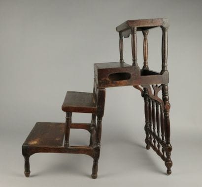 A four-step stool-style chair made of dark...