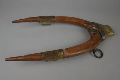 Wooden, brass, and leather donkey yoke with...