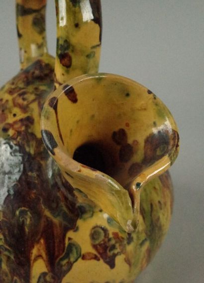 Glazed terracotta jug with a marbled design...