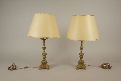 Pair of bronze candlesticks resting on a...