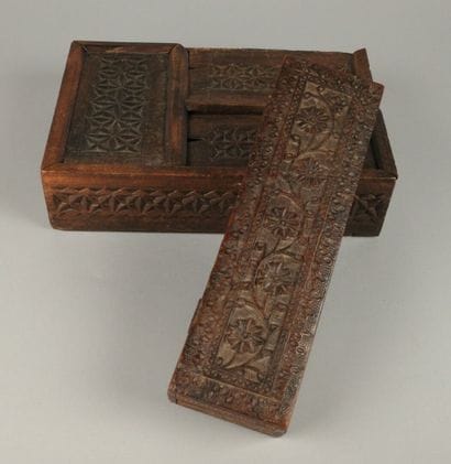 Set includes: - A carved wooden box with...