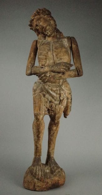Carved wooden Christ in bonds with traces...