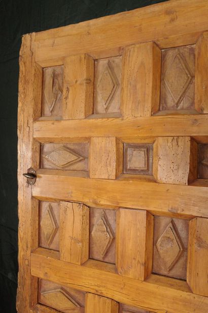 Antique paneled door carved with diamond-shaped...